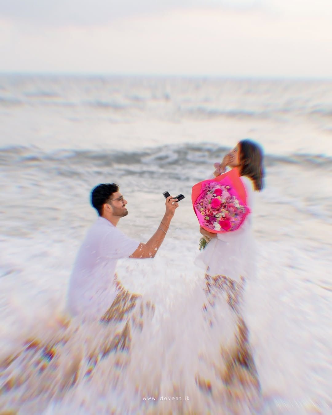 Romantic beach surprise proposal in Sri Lanka with man kneeling and holding ring, emotional reaction moment