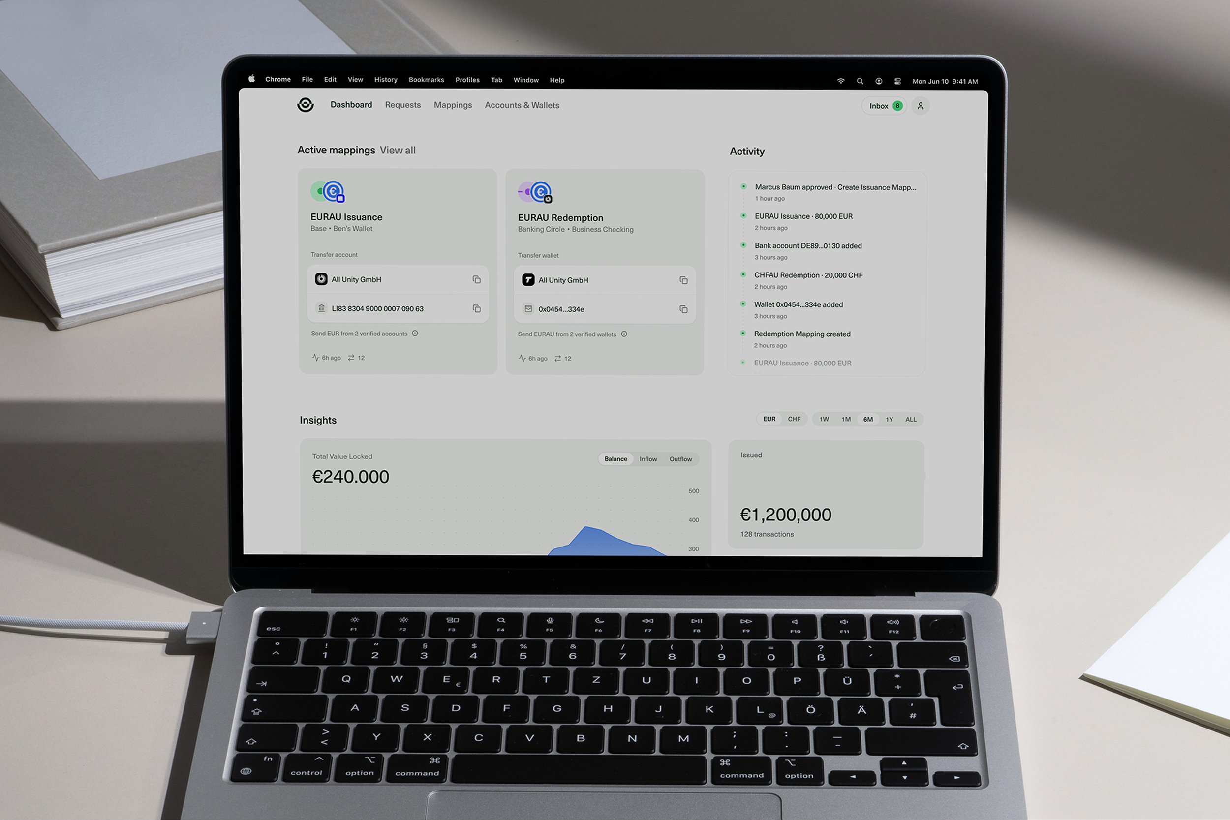 Open laptop on a desk displaying a financial dashboard with active mappings, recent activity, and euro balance and transaction insights.