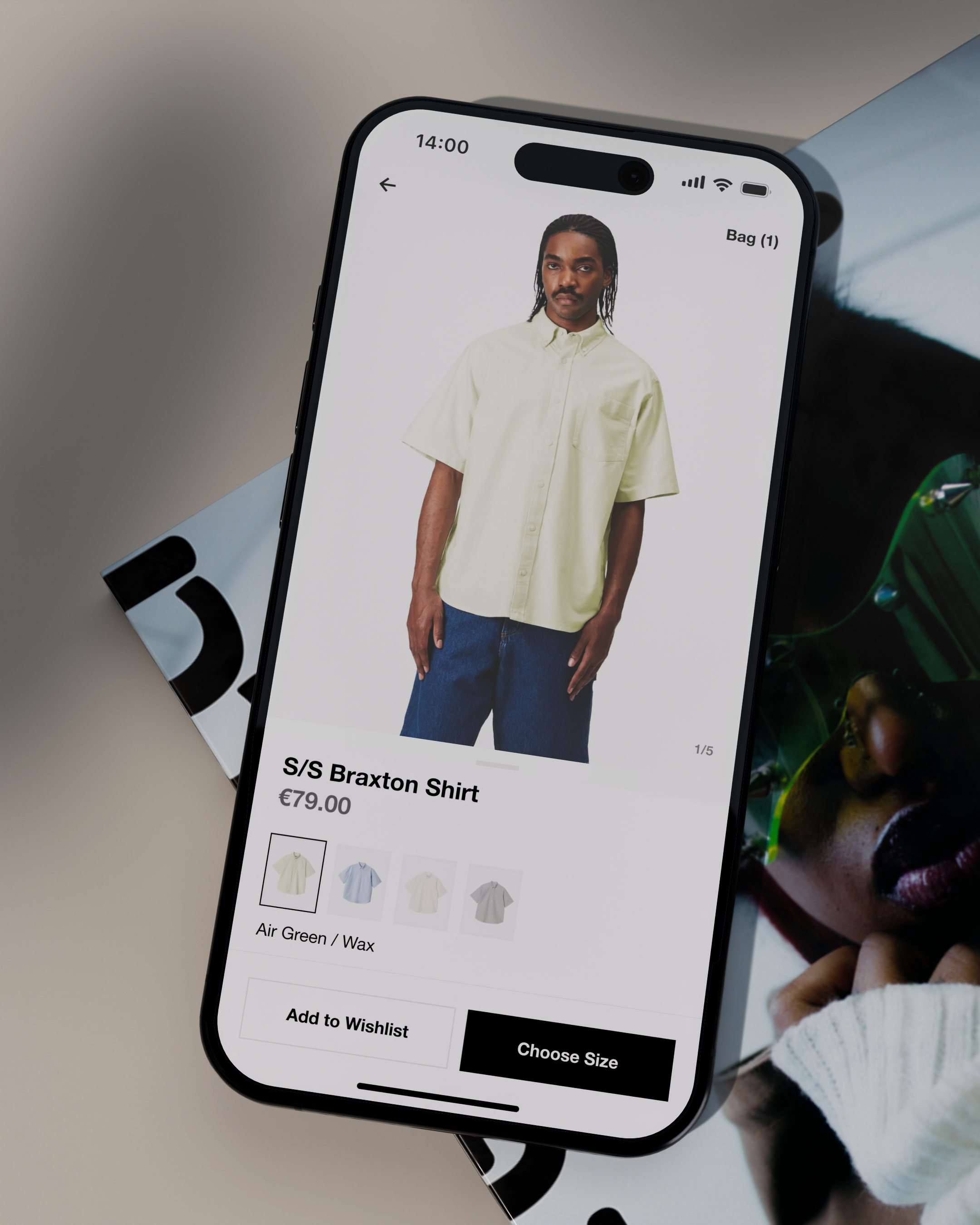 A smartphone screen displays an e-commerce product page for the S/S Braxton Shirt priced at €79.00, shown on a male model wearing the light green shirt with blue shorts, with color swatches visible below.