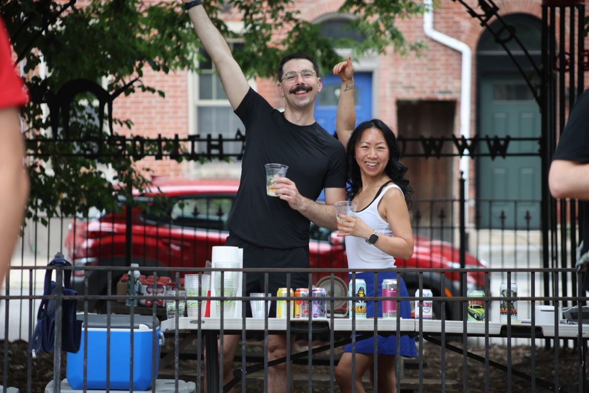Volunteers raising a toast at the Yappy Hour drinks table