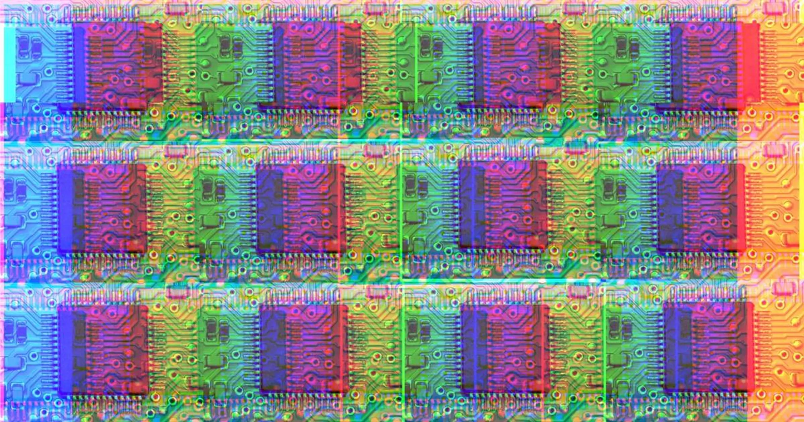 Rows of computer chips on a circuit board, vibrant with red, blue, and green color shifts.