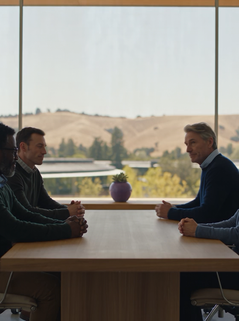 Two coworkers talking across a conference table