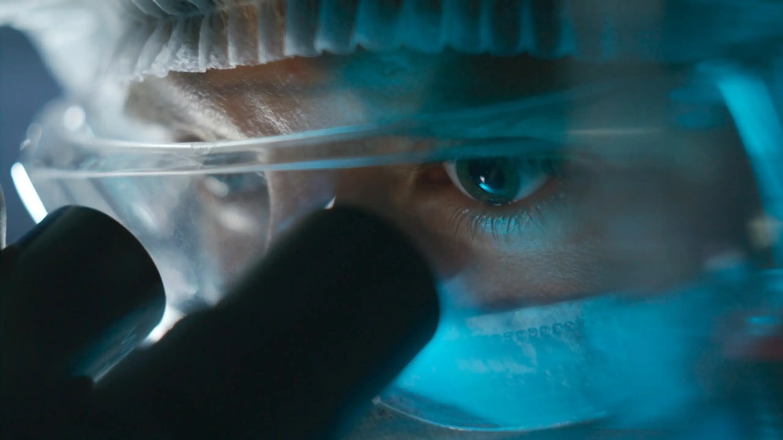 Scientist looking through microscope