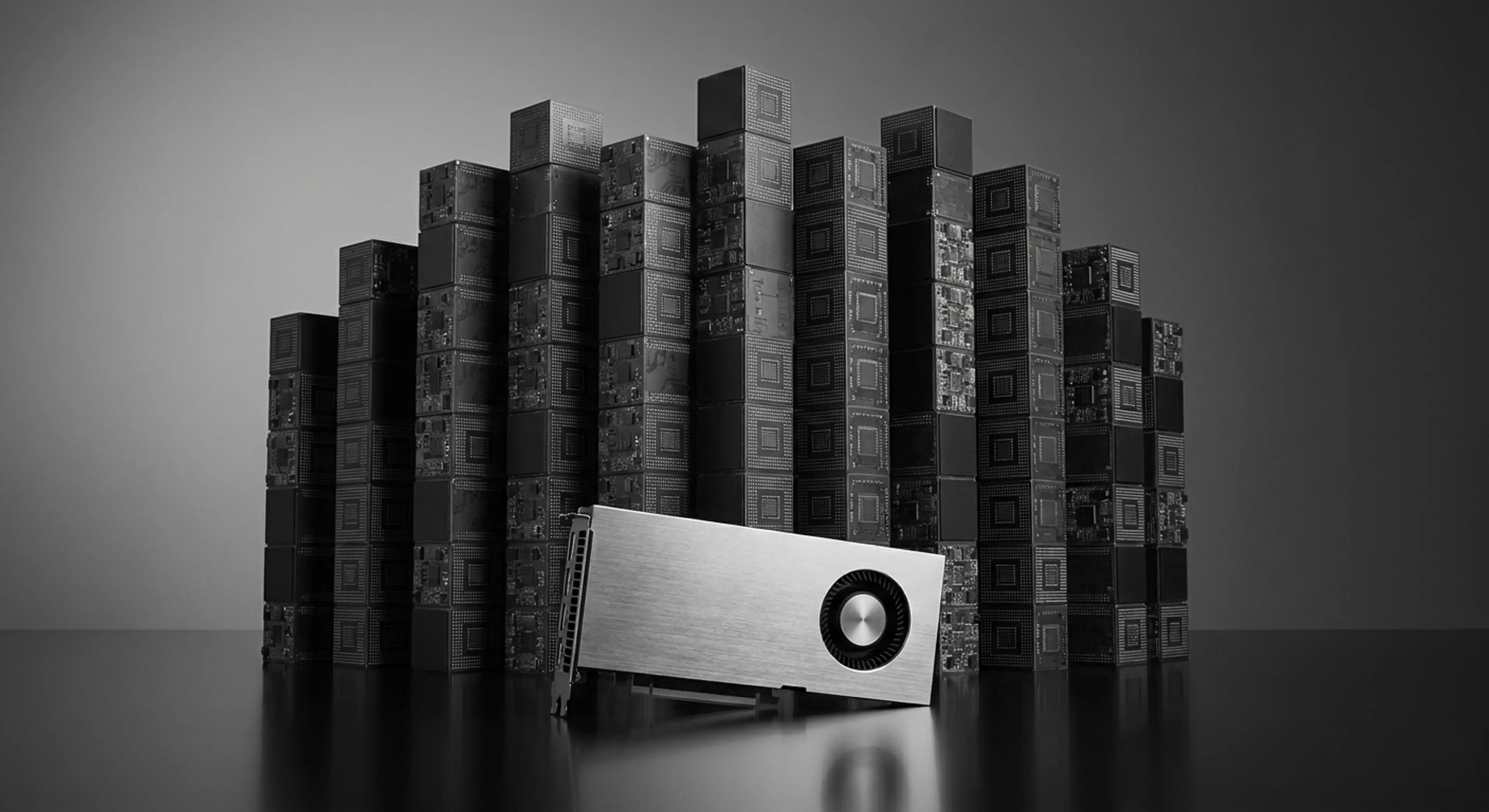 A silver graphics card is angled in front of stacks of dark, patterned blocks, arranged like a bar graph, in grayscale.