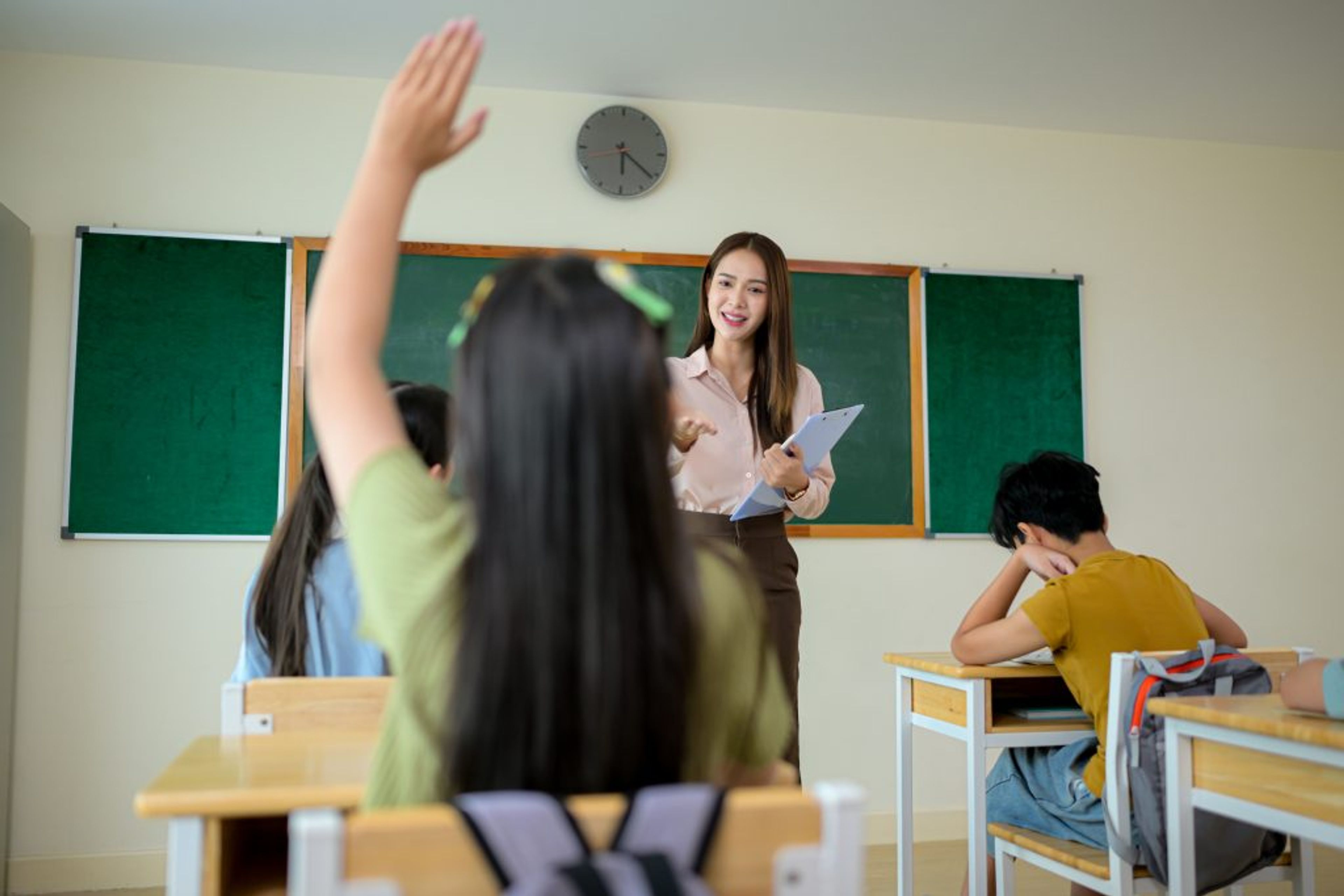 Student raising hand in class