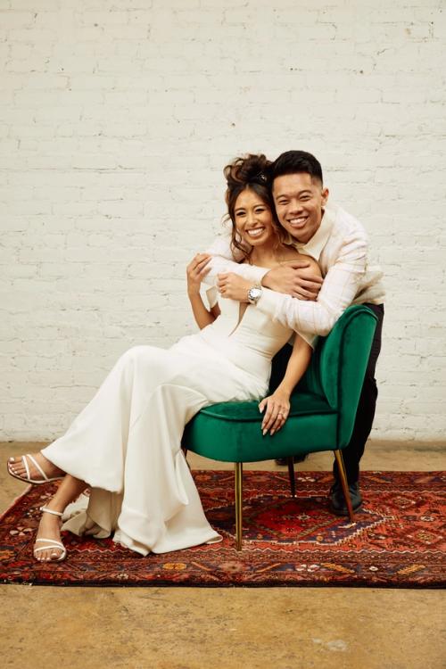 Laughing wedding couple portrait against white brick wall — The Lounge Booth
