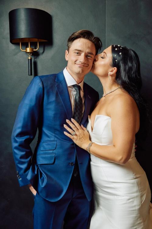 Wedding couple portrait at a moody dark-toned reception venue — The Lounge Booth