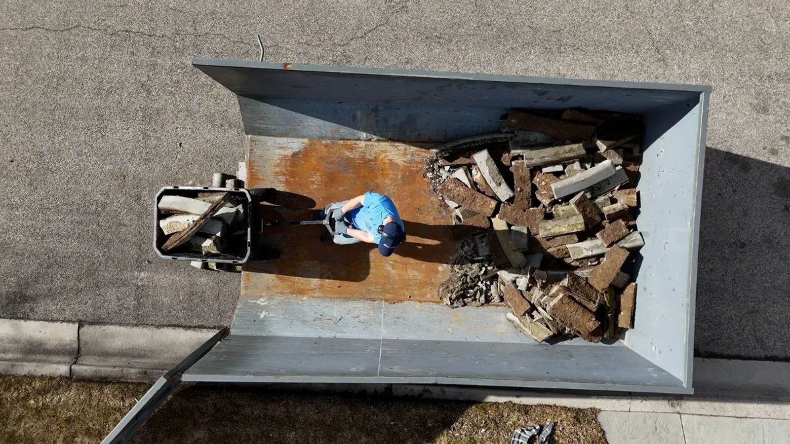 Concrete curbing pieces being loaded onto the Top Shelf truck