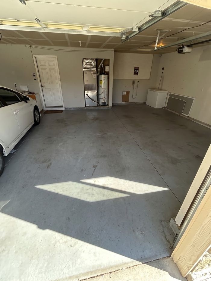 After: the same two-car garage, emptied and swept by Man of Steel Junk Removal