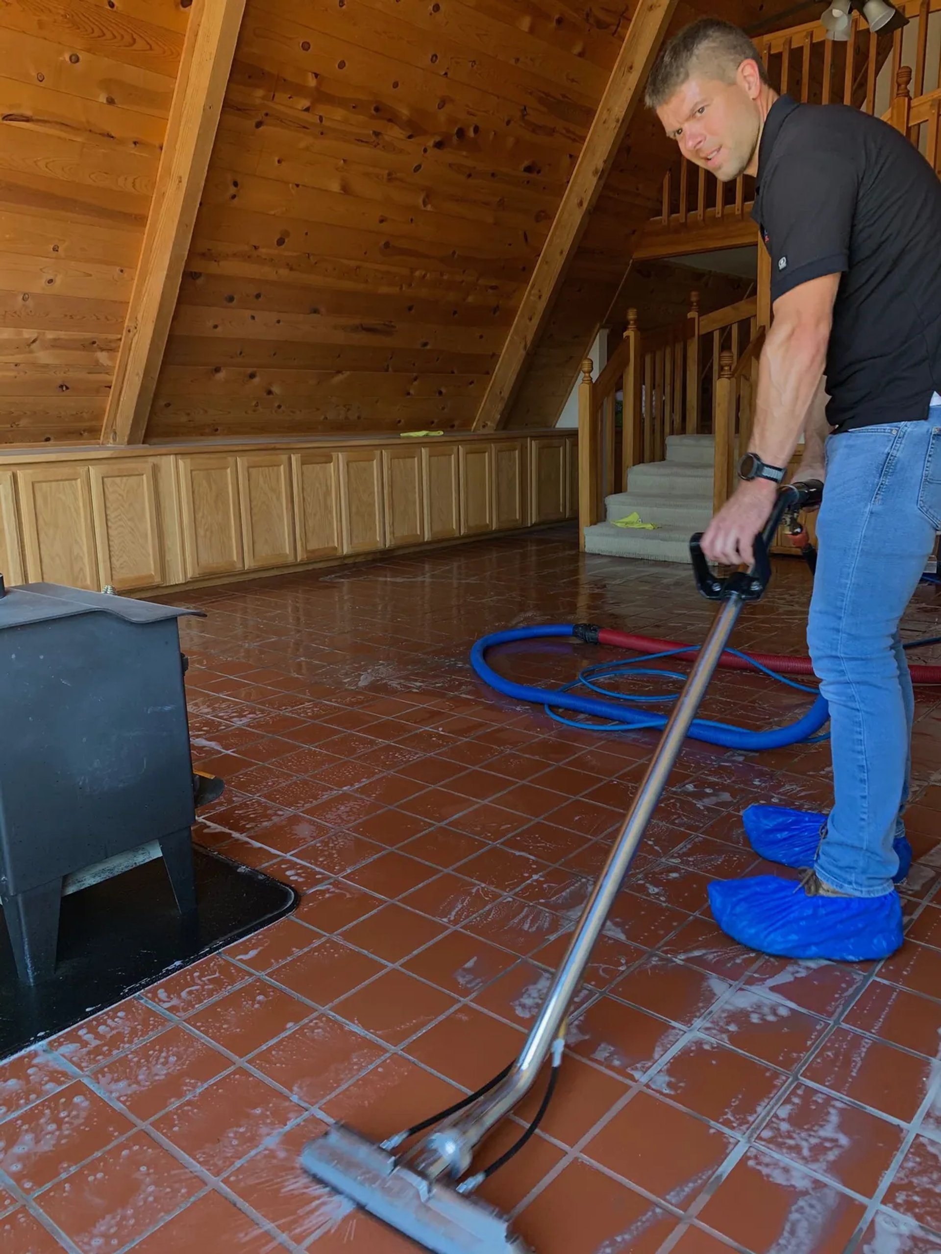 A Freedom Cleaning technician deep-cleaning a tile floor