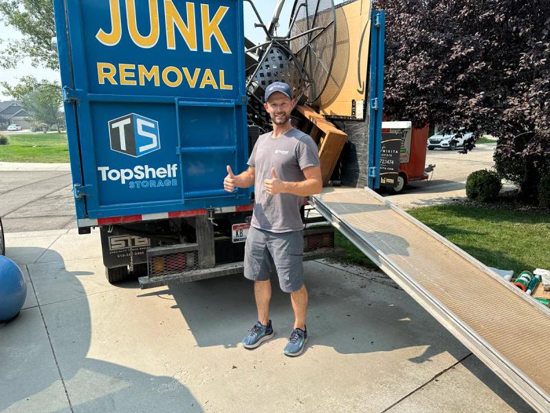 Top Shelf crew member giving a thumbs up after loading patio furniture onto the truck