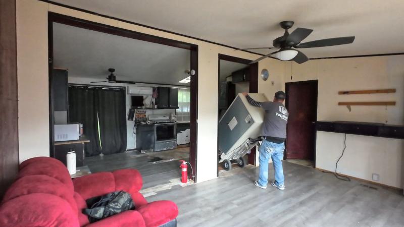 Top Shelf crew wheeling a fridge on a dolly through a home interior in Meridian Idaho