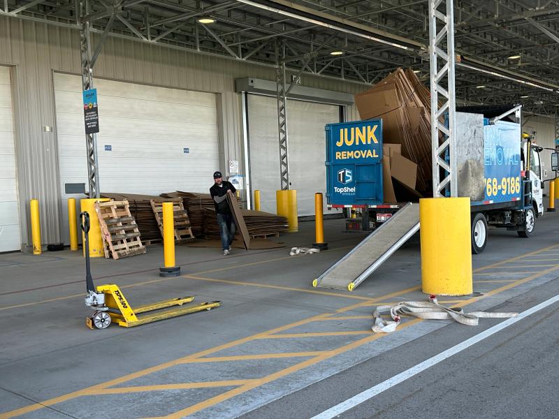 Top Shelf crew loading flattened cardboard and pallets from a warehouse into the branded truck in Eagle Idaho
