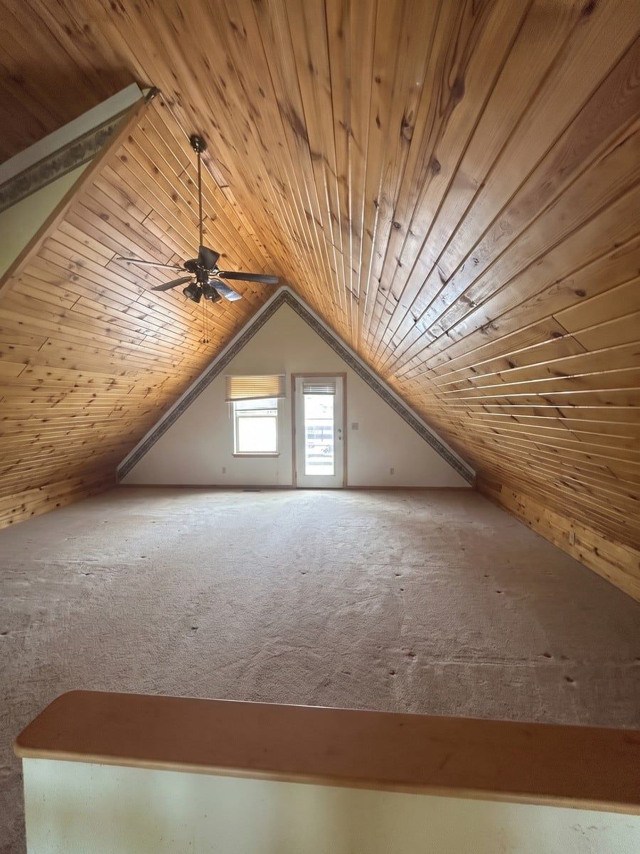 After: the same A-frame cabin living room, emptied and swept by Man of Steel Junk Removal