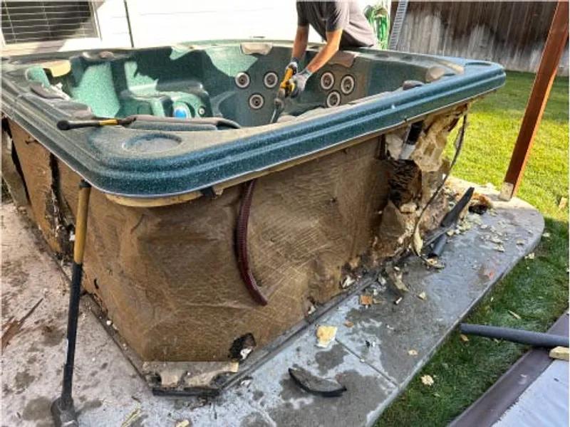 Hot tub being demolished and broken apart for removal in Caldwell Idaho