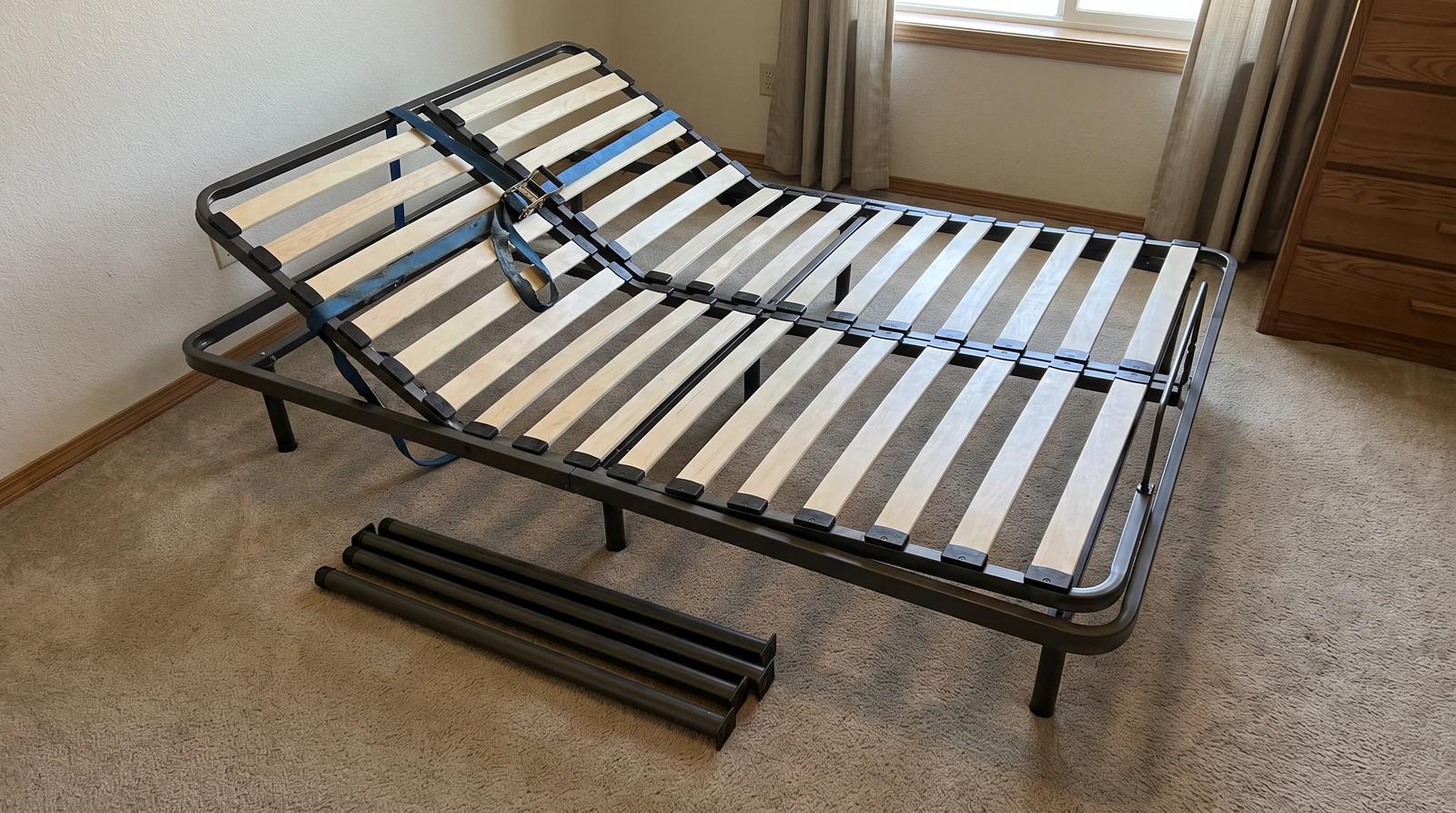 Adjustable bed base strapped flat with its legs removed, ready for furniture removal from a bedroom in Eagle, Idaho