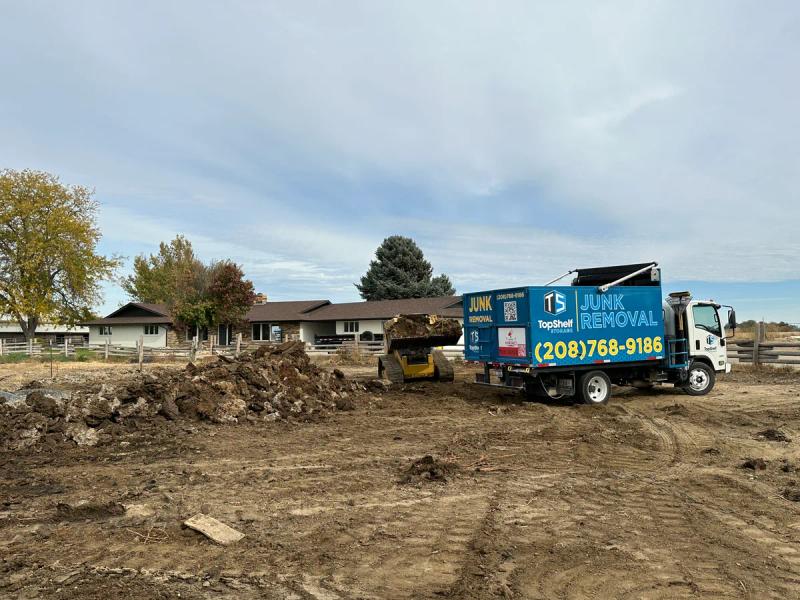 Top Shelf skid steer loading manure for removal in Caldwell Idaho