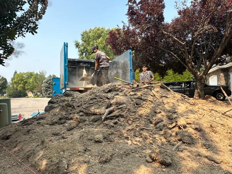 Top Shelf crew shoveling dirt during a bulk material removal job