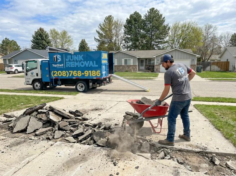 Top Shelf crew removing broken asphalt from a residential property in Middleton Idaho