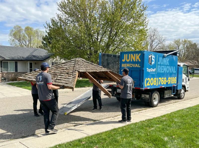 Top Shelf crew member using tools to dismantle an old gazebo in Middleton Idaho