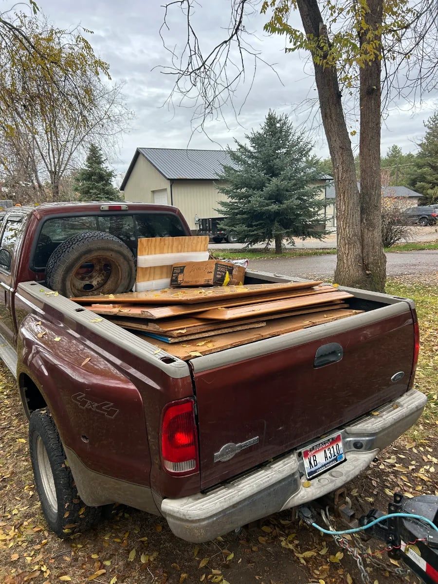 Pickup truck bed loaded with old lumber and fence boards