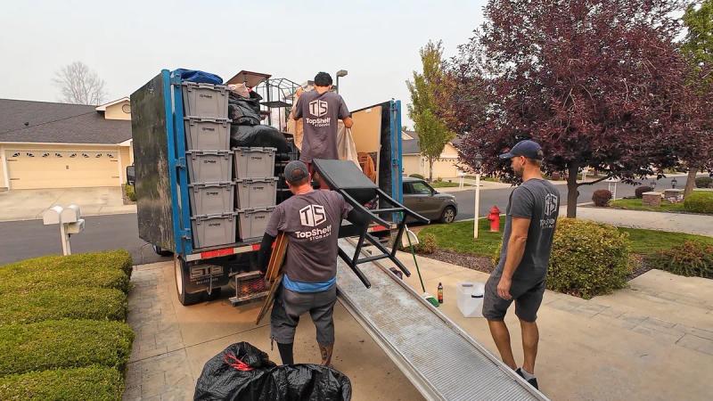 Top Shelf crew loading estate cleanout items into the truck