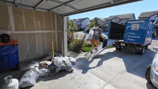 Top Shelf crew loading items from a garage during a house cleanout in Meridian, Idaho