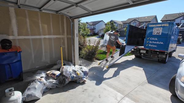 Top Shelf crew loading items from a garage during a house cleanout in Meridian, Idaho