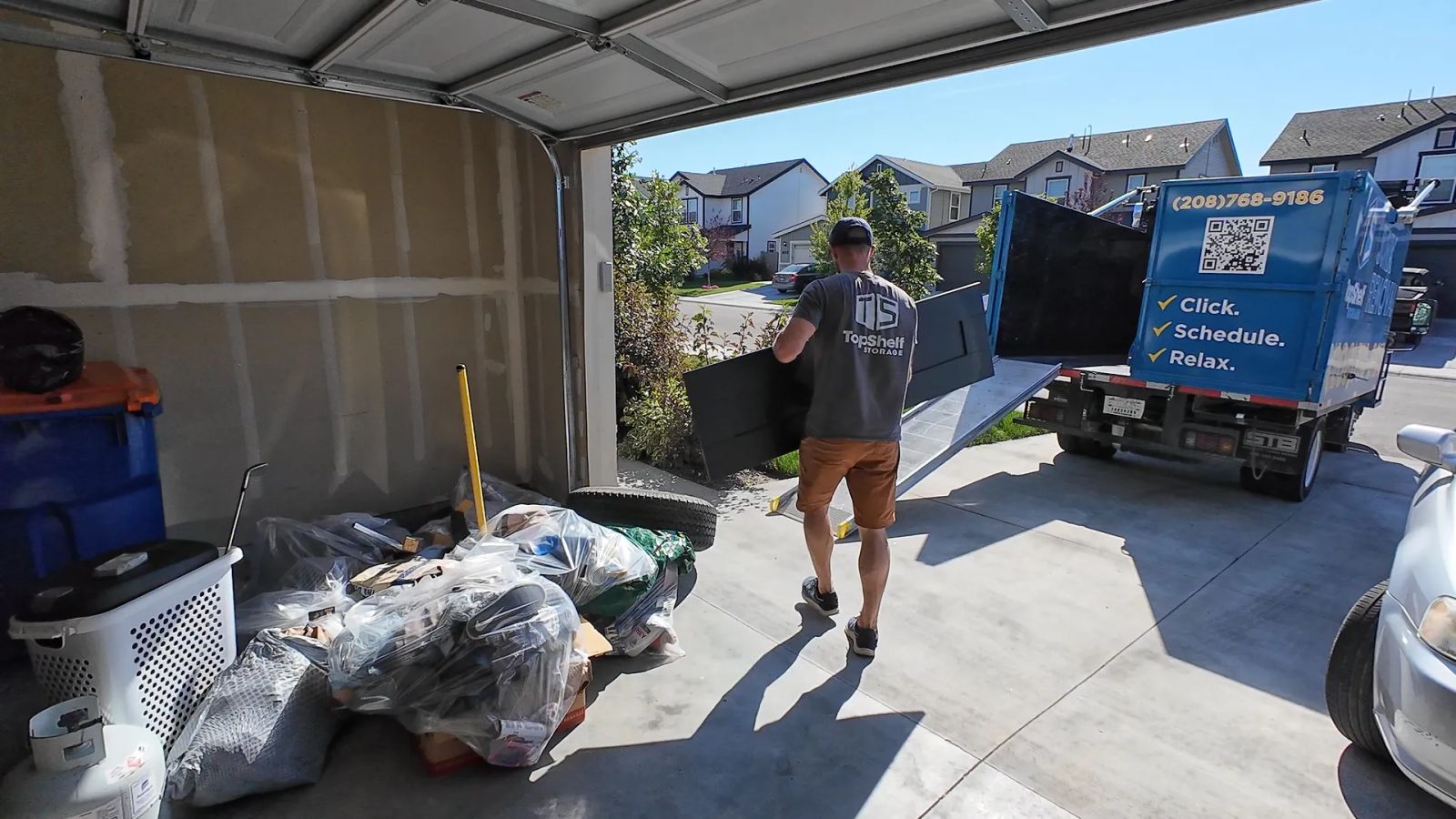 Top Shelf crew sorting and removing items during a garage cleanout in Boise Idaho