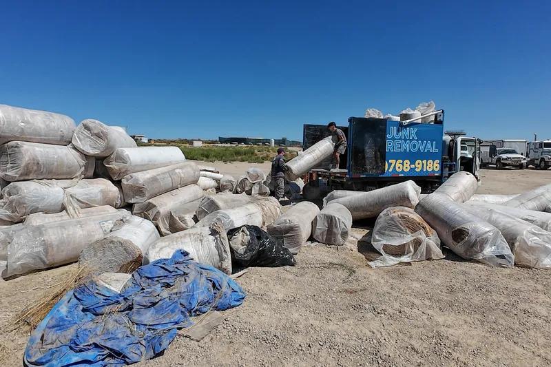 Top Shelf crew removing large carpet rolls from commercial property in Emmett Idaho