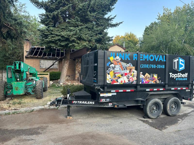 Top Shelf trailer and heavy equipment at a house demolition site in Boise Idaho