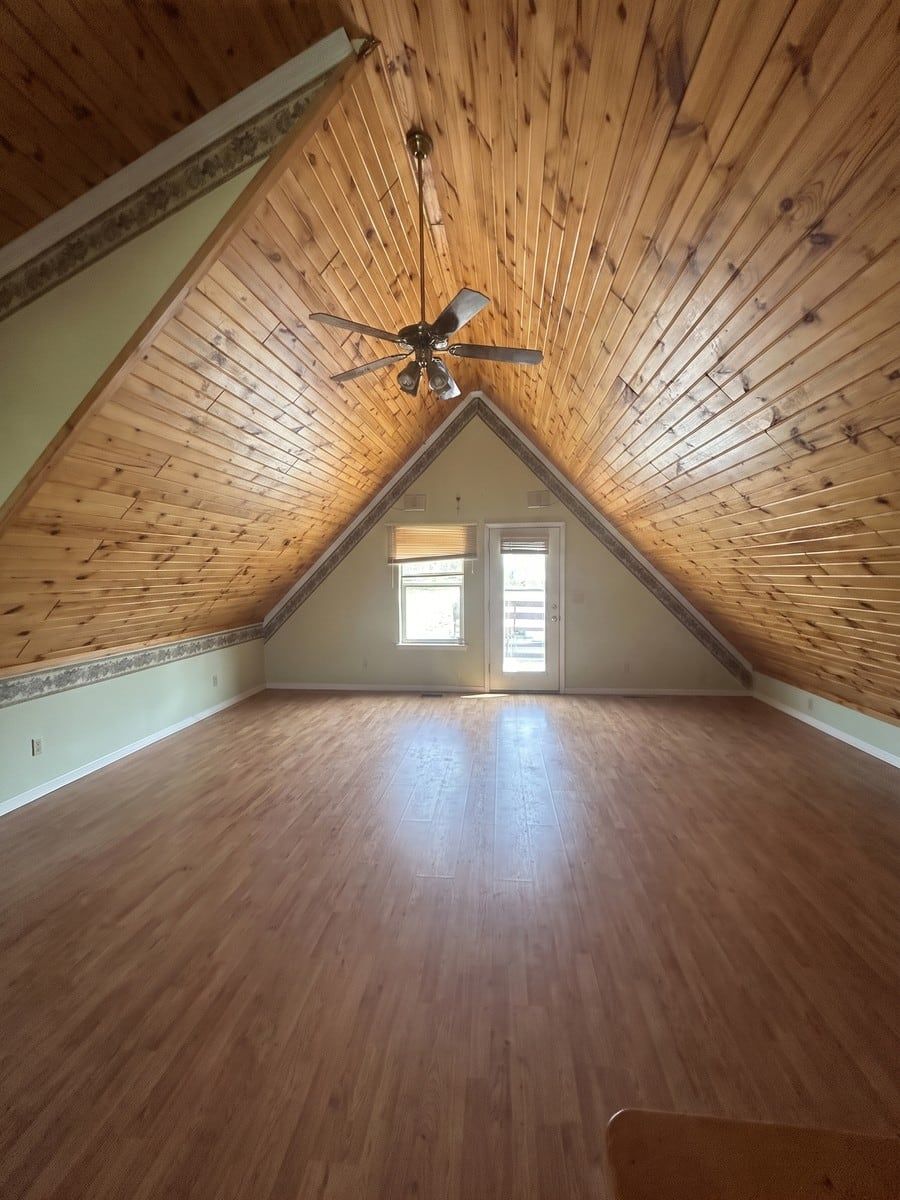 After: the same A-frame cabin living room, emptied and swept by Man of Steel Junk Removal