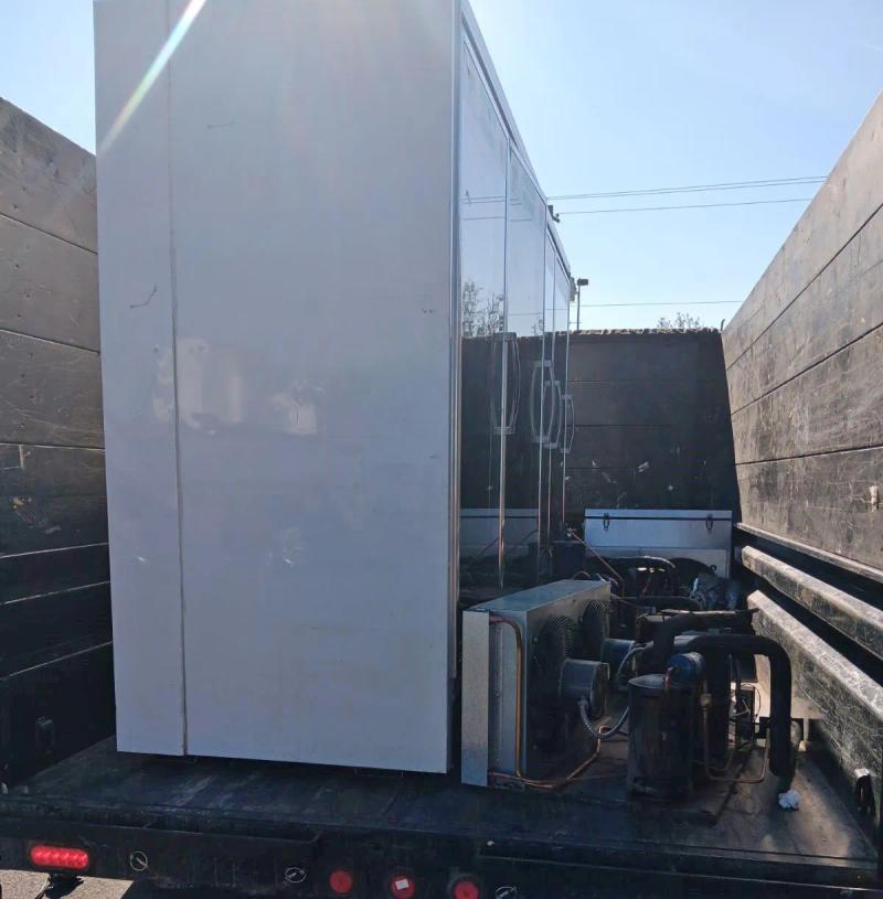 Walk-in cooler compressor loaded on Top Shelf truck after commercial removal