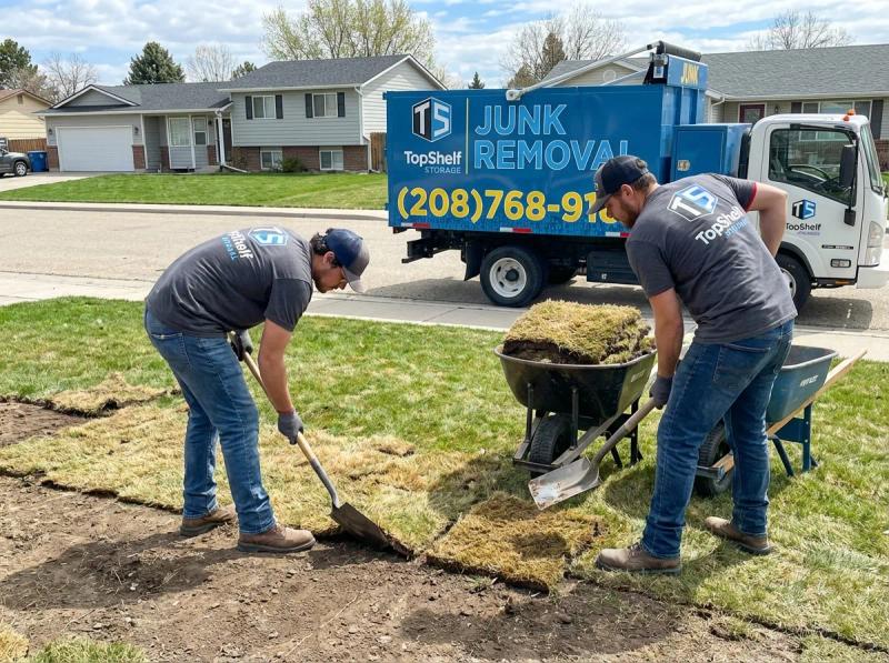 Top Shelf junk removal team hauling sod to the branded truck in Caldwell Idaho