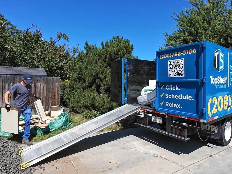 Top Shelf branded truck loaded with old cabinets for removal in Boise Idaho