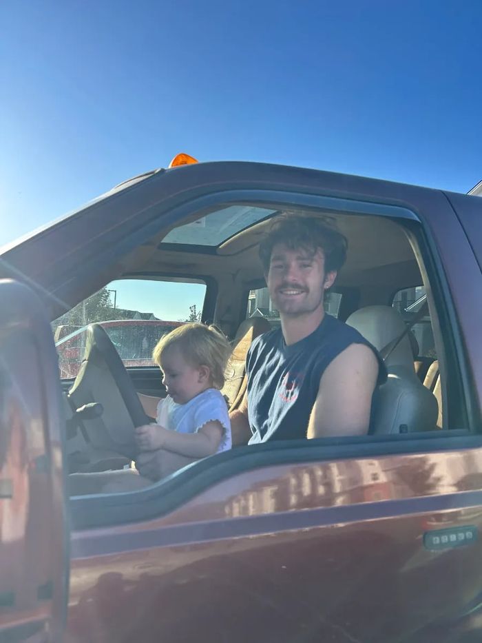 Tommy Simonson of Man of Steel Junk Removal in the cab of his truck with his daughter