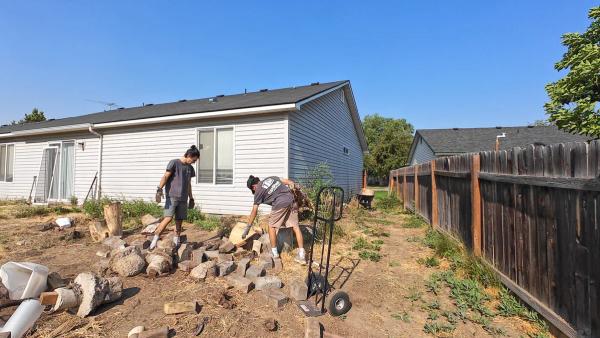 Top Shelf crew removing a concrete slab and wood debris
