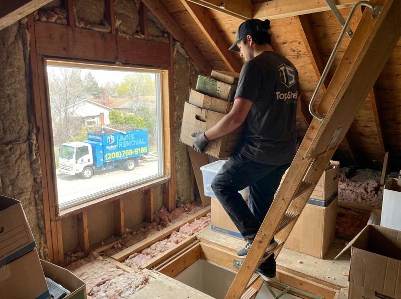 Attic cleanout showing stored items and insulation in a Boise Idaho home