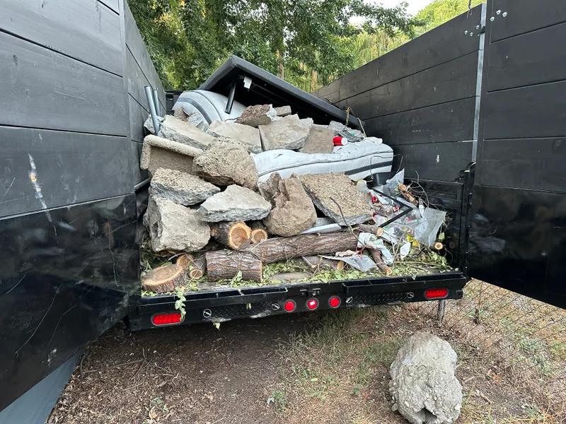Junk removal crew loading debris at a property in Nampa Idaho