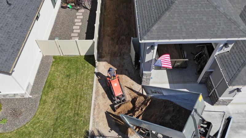 Aerial view of Top Shelf skid steer loading dirt for removal