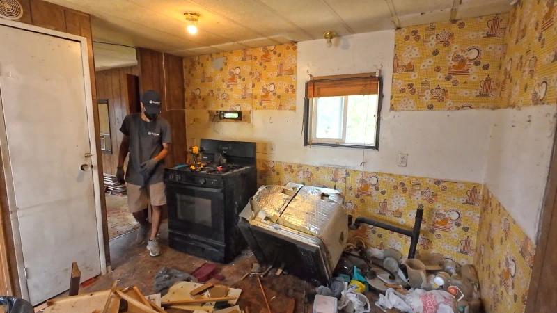 Trashed kitchen being cleaned out at a rental property in Kuna Idaho