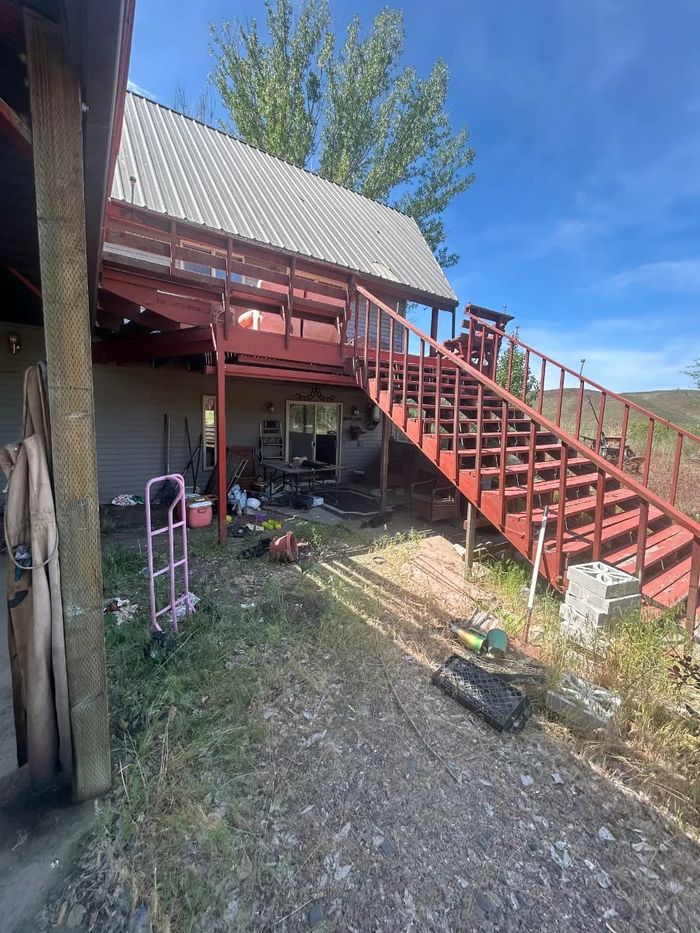 Exterior deck stairs and debris at a demolition job