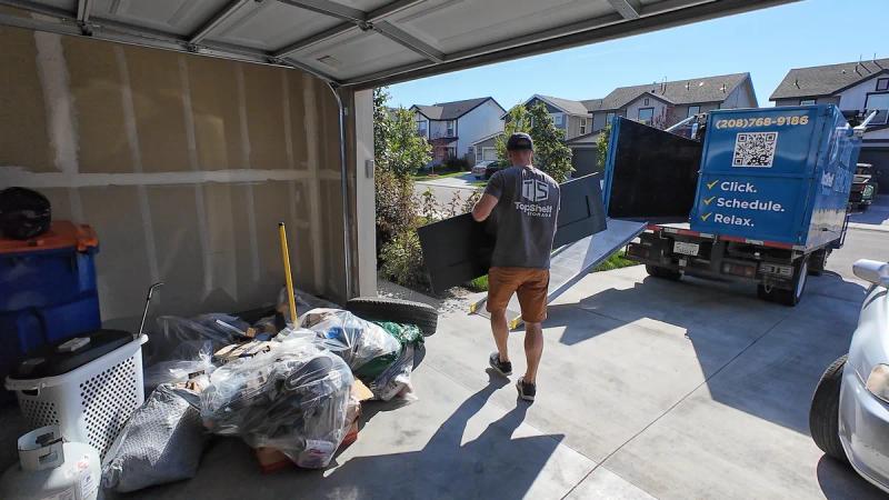 Top Shelf crew loading leftover garage sale junk into the truck
