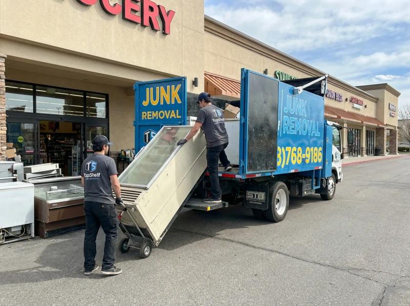 Top Shelf junk removal team hauling grocery store items to the branded truck in Star Idaho