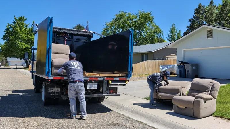 Top Shelf crew picking up a recliner chair curbside in Boise Idaho