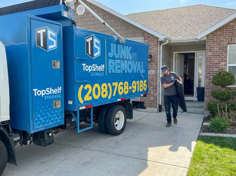 Top Shelf crew removing an old television from a residential property in Caldwell Idaho
