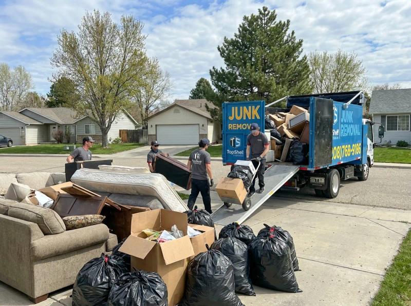 Top Shelf crew member loading bulk trash into the junk removal truck in Boise Idaho