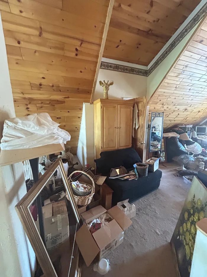 Bedroom with furniture and belongings before a cleanout