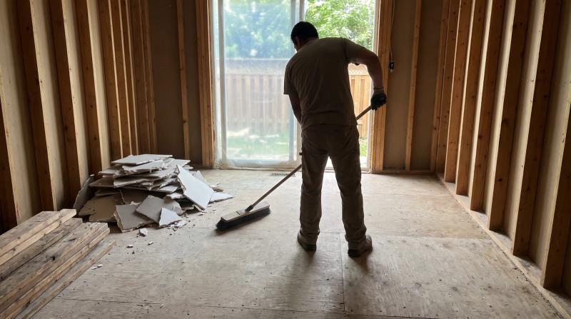Gutted room with stacked broken drywall and old lumber ready for demolition cleanup during a remodel in Boise, Idaho
