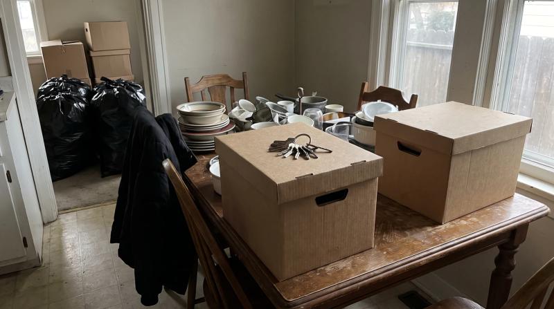 Closed file boxes and a ring of house keys on a kitchen table during an estate hoarding cleanup in Emmett, Idaho